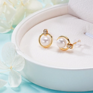 Elegant white freshwater pearl stud earrings in gold rings with crystal accents