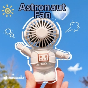 White astronaut portable handheld desk fan with adjustable knob against a blue sky background