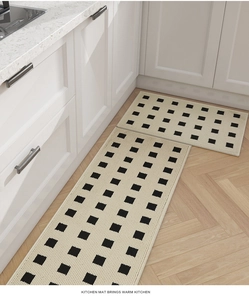 Detail of beige kitchen mats with black checkerboard pattern on wood flooring