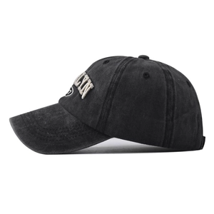 Detail of white 3D letter embroidery LYN on washed cotton baseball cap with curved brim