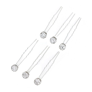 Detail of silver U-shaped bridal hair pins with shimmering pavé crystal ball toppers