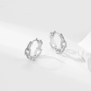 Detail of silver chain hoop earrings with rectangular and round cubic zirconia stones