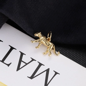 Macro shot of a golden leopard pendant featuring detailed spot textures and polished metal