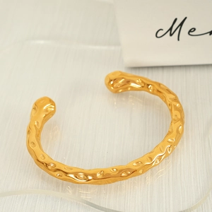 Minimalist gold hammered cuff bracelet with textured lava finish in vintage style