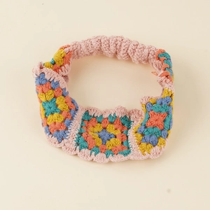 Ethnic style granny square crochet headband with colorful floral patterns and elastic strap