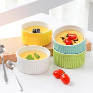 Close-up of heart-shaped ceramic dipping bowls in various pastel colors on a table