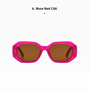 Detail of rose red hexagonal sunglasses with silver rivets and brown lenses