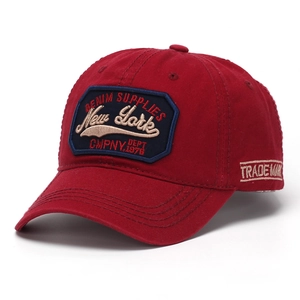 Detail of New York embroidery on red cotton baseball cap with vintage patch