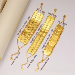 Close-up of 24k gold plated coin bracelets showing detailed relief textures and charms