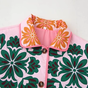 Women's pink floral jacket with lapel and resin buttons on white background