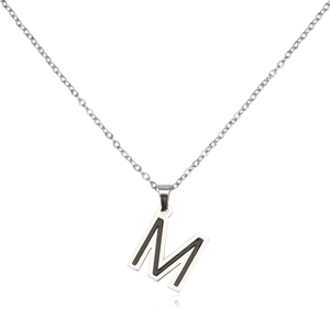 Detail of silver stainless steel letter M pendant with black enamel inlay on thin chain