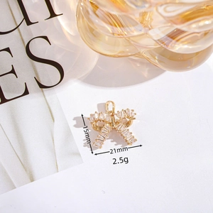 Golden bow pendant necklace accessory with clear cubic zirconia stones in macro view