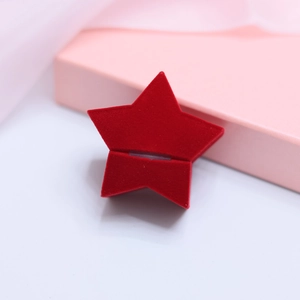 Macro shot of a red star-shaped velvet jewelry box for wedding rings and gifts