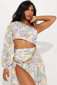 Detail of floral cut-out swimsuit featuring a one-shoulder sleeve and gold chain waist