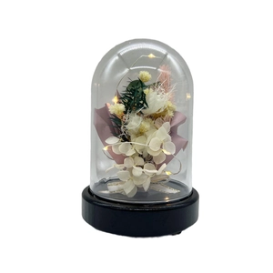 Eternal flower arrangement in plastic dome with LED lights and black wooden base