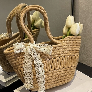French style straw bucket bag with white lace bow and natural hand-woven wavy texture