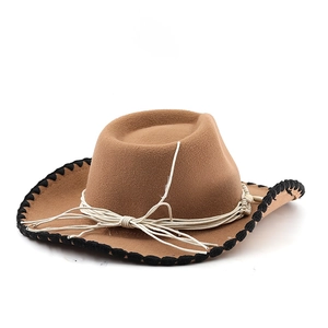 Detail of camel wool fedora with black stitched brim and decorative white rope band