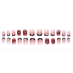 Elegant nude pink French press-on nails with chocolate tips, pearls, and rhinestones