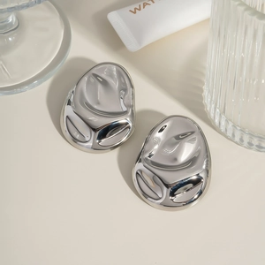 Macro shot of silver abstract geometric earrings with a polished metallic finish