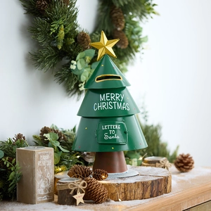 Christmas tree shaped metal mailbox with Merry Christmas text and golden star topper