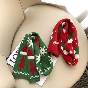 Children's knitted Christmas scarf in red and green colors with festive holiday patterns