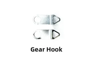 Macro detail of two metal clock movement hangers with circular holes and triangular hooks