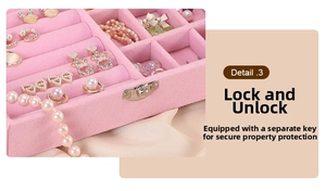 Pink velvet jewelry box detail showing metal lock mechanism and internal earring slots