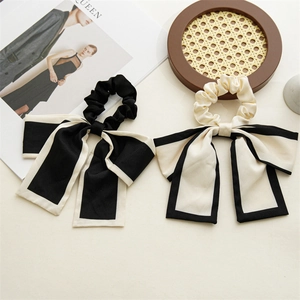 Detail of high-quality bow hair scrunchies with elegant contrast borders and satin finish