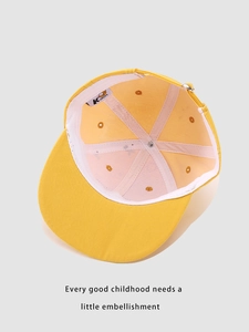 Detailed interior view of yellow kids baseball cap showing stitching and breathable eyelets