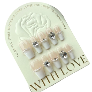 French style press-on nails in nude and white with pearls and heart rhinestones
