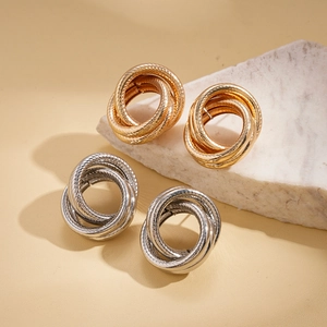 Minimalist geometric twisted knot stud earrings in polished gold and silver finishes