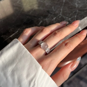 Detail view of S925 silver ring with a pink oval gemstone and sparkling zircon accents