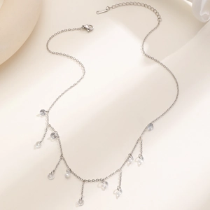 Detail of silver stainless steel fringe necklace with sparkling clear zircon crystals