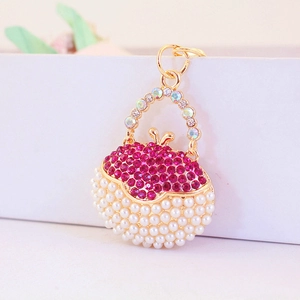 Chic golden handbag keychain with pink rhinestones and white pearls for women