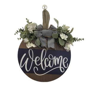 Welcome wooden door wreath with striped bow, white flowers and eucalyptus leaves