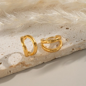 Minimalist double-layer C-shaped gold-plated hoop earrings on elegant stone surface
