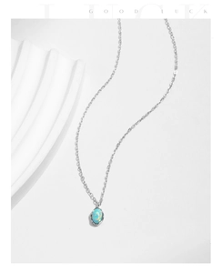 Detailed view of s925 silver necklace featuring an iridescent blue opal stone pendant