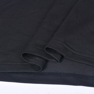 Macro shot of double-needle stitching and high-density black fabric on the hemline