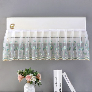 Detailed embroidery of floral vines on a white lace air conditioner dust cover