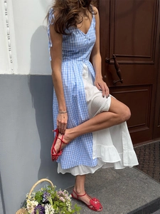 Detailed shot of blue plaid dress with single-breasted buttons and white layered ruffle hem