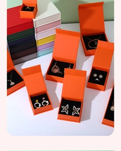 Multiple colorful magnetic flip jewelry boxes with black sponge inserts for storage