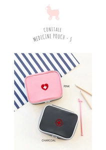 Detail of pink and charcoal travel medicine pouches with cross embroidery and zippers