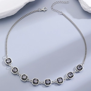 Detailed view of silver necklace with grey faceted crystals and lobster clasp closure