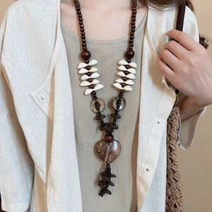 Bohemian long necklace with coconut shell wood beads and white heart shell pendant