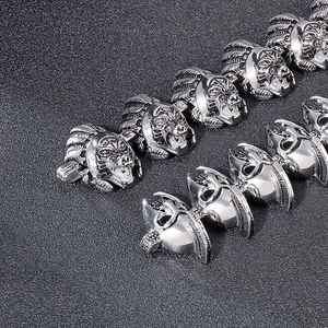 Detailed shot of vintage titanium steel bracelet featuring carved warrior head charms