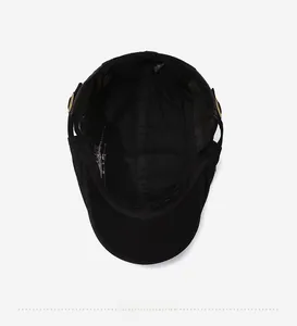 Detail view of cotton beret cap interior with gold buckle and reinforced seams