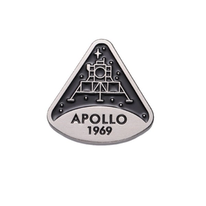 Apollo 1969 moon landing commemorative enamel pin with lunar module on a black triangle