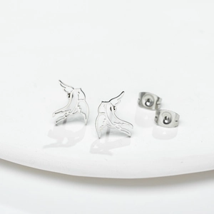 Minimalist hollow bird stud earrings in stainless steel on white tray display