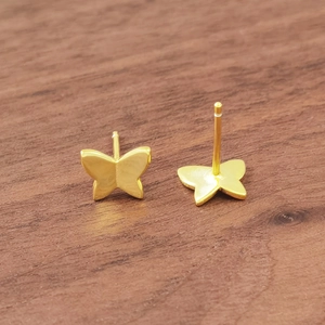 Minimalist S925 sterling silver butterfly stud earrings in golden finish on wood