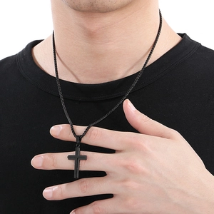 Close-up of black matte stainless steel cross necklace on a model for a realistic look